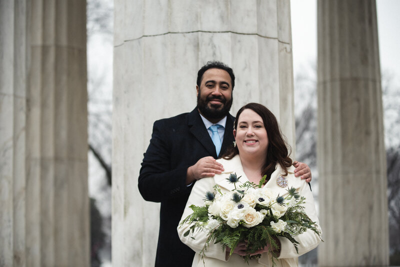 Bridal bouquet and groom in front of War Memorial in Washington, DC