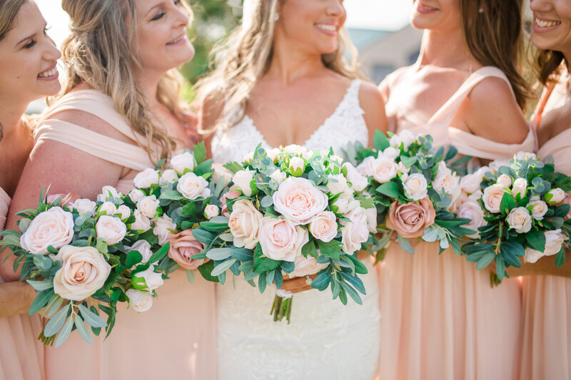 A wedding photo featuring gorgeous pink, blush and white florals.