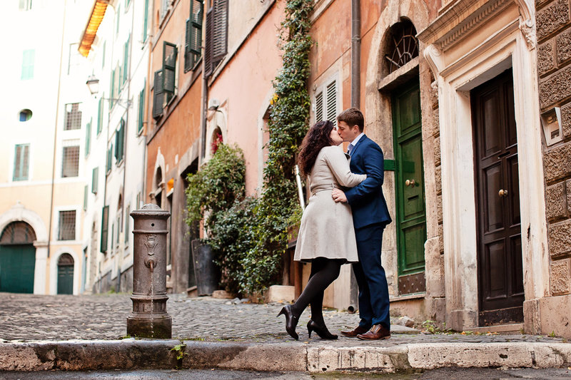 A couple kissing near a roman water fountain. Taken by Rome Honeymoon Photographer, Tricia Anne Photography
