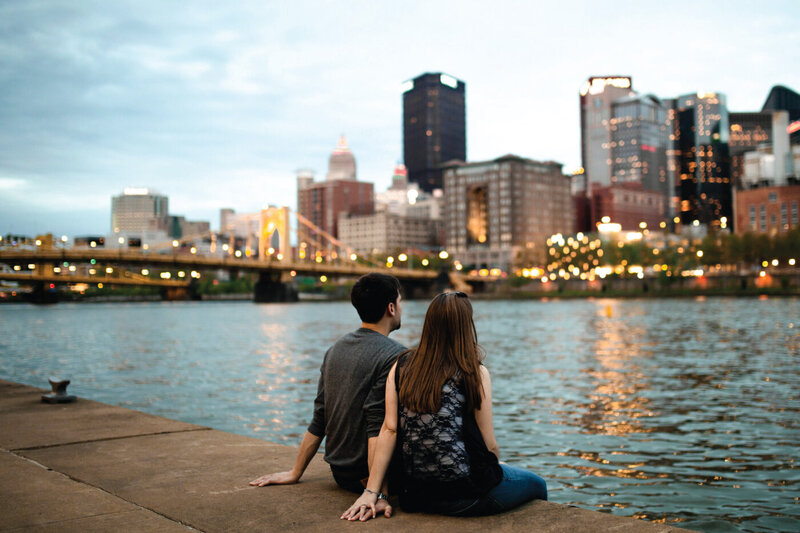 couple-sitting-looking-at-city