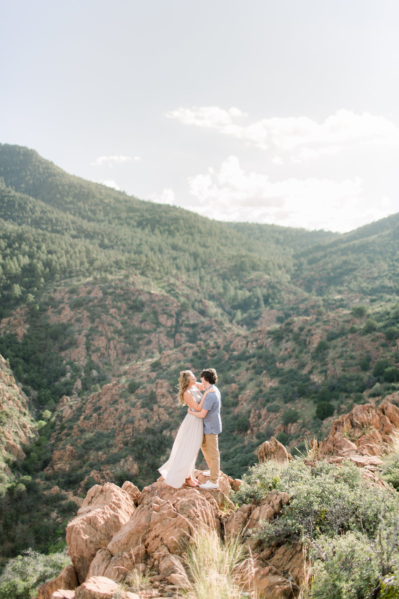 couple standing on cliff edges