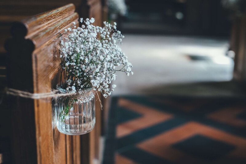 church pews with white flowers