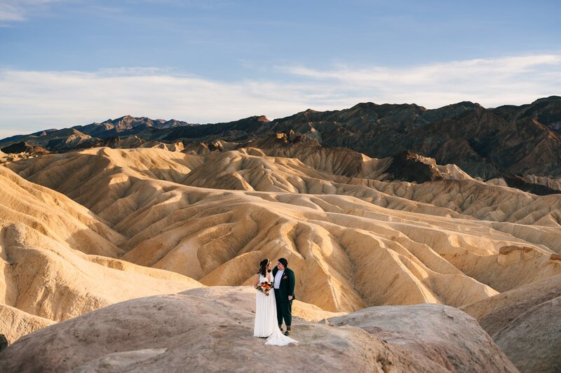 A couple looking at each other during their elopement at Death Valley National Park, Zabriske Point.