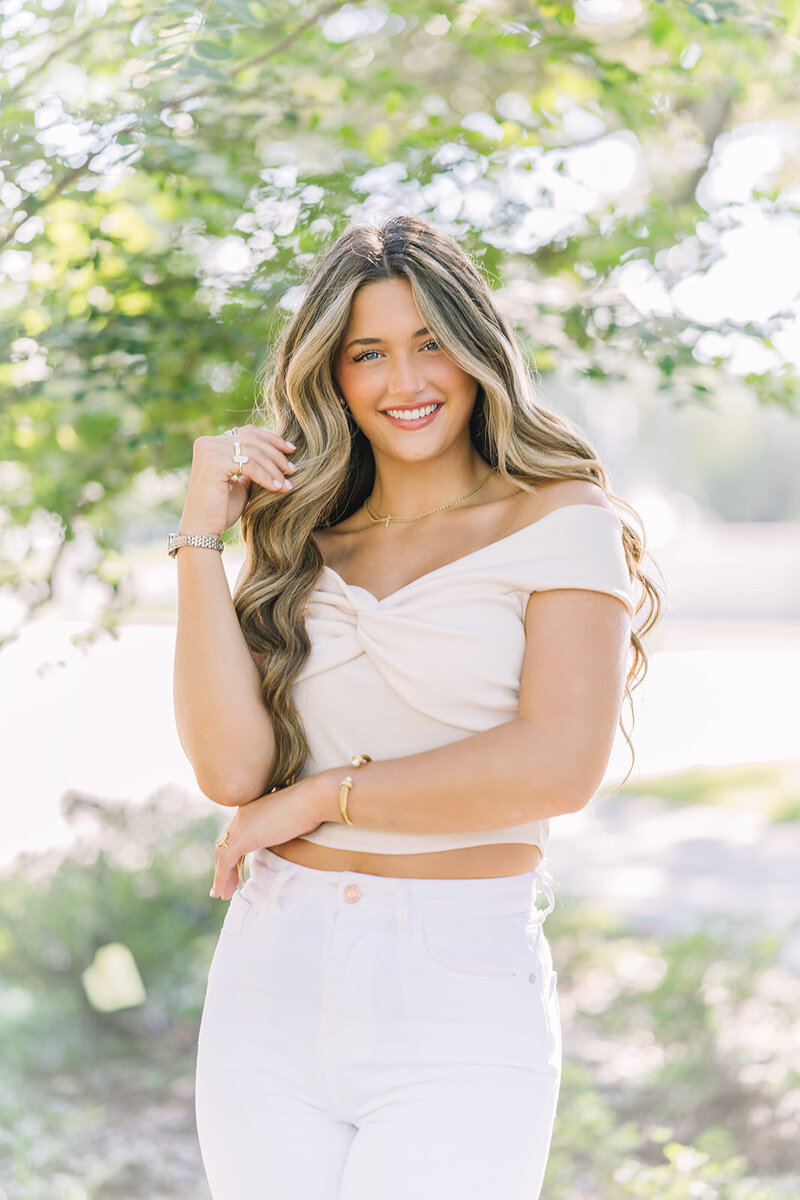 Senior plays with her hair at Baton Rouge photo session.