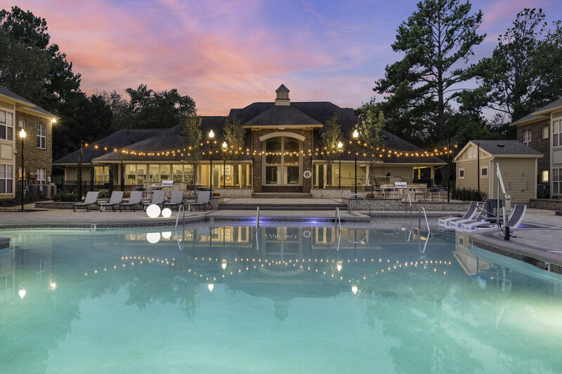 Commercial interior design for a beautiful outdoor pool area with string lights and plenty of seating. Commercial design by Gracious Home Interiors, luxury interior design in Waxhaw NC and across the east coast.