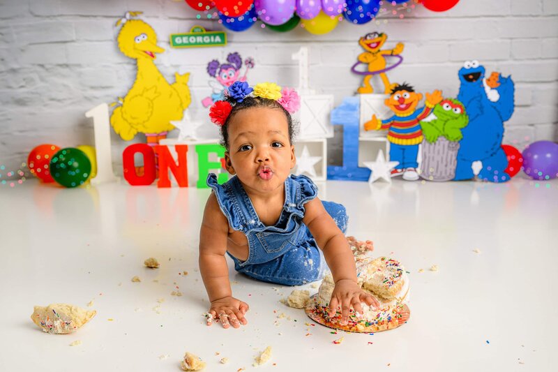 little girls plays with cake in her sesame street smash
