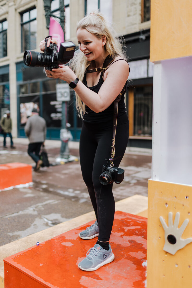 Photographer smiling while taking picture