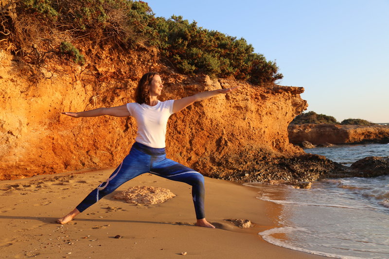 Student in Greece 200 Hour Yoga Teacher Training Program poses in Warrior 2