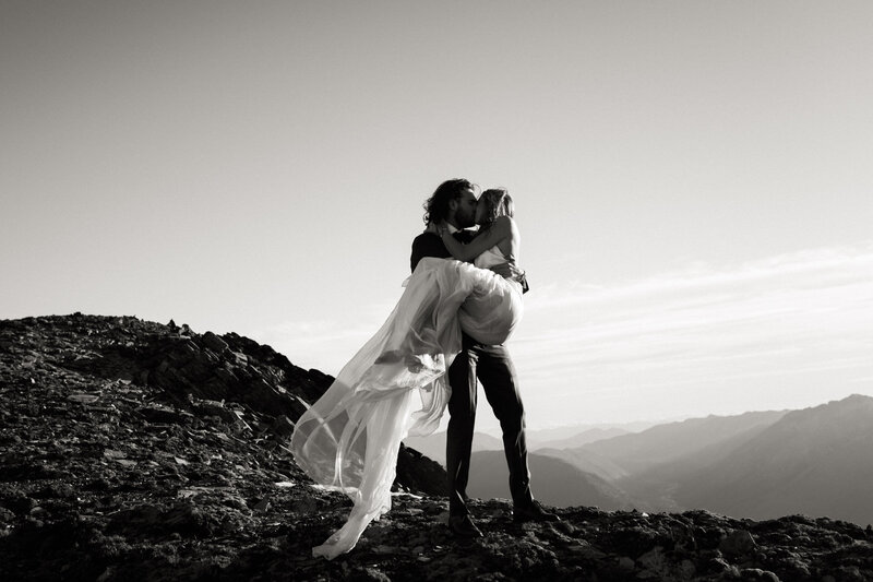The Lovers Elopement Co - Bride and Groom on mountain top in Queenstown - helicopter wedding