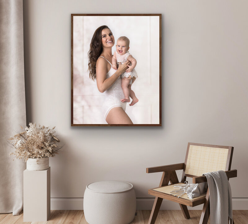 Canvas portrait on the wall of a gorgeous smiling mother and a baby in London