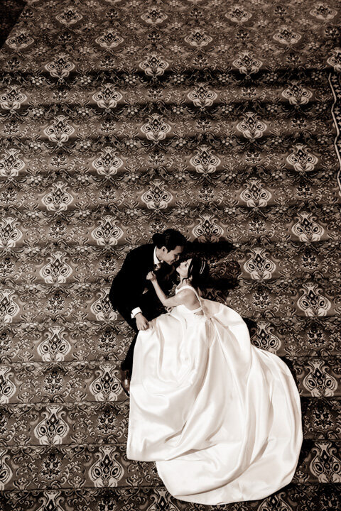Wedding couple lying on the stairs