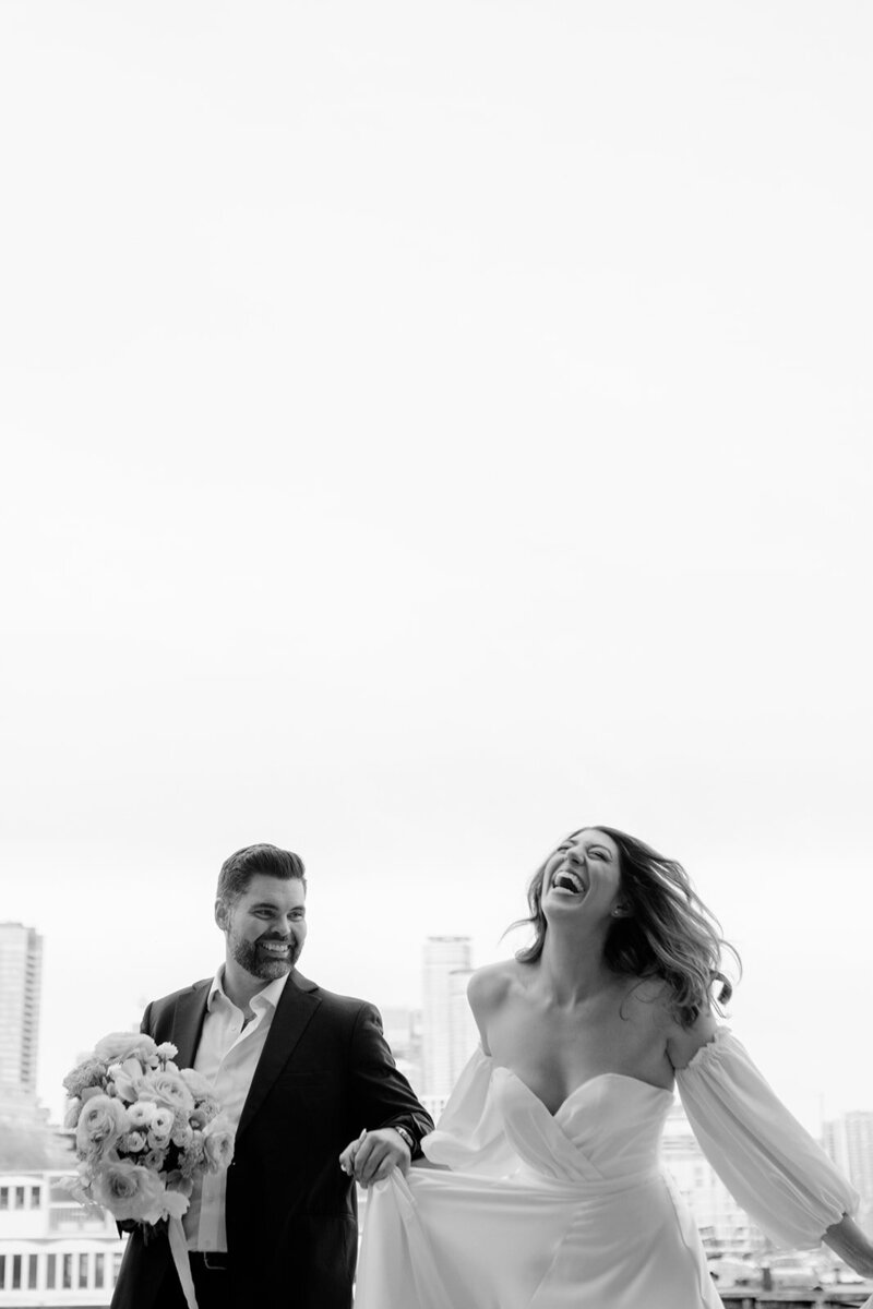 Laughing couple in a candid wedding photoshoot.