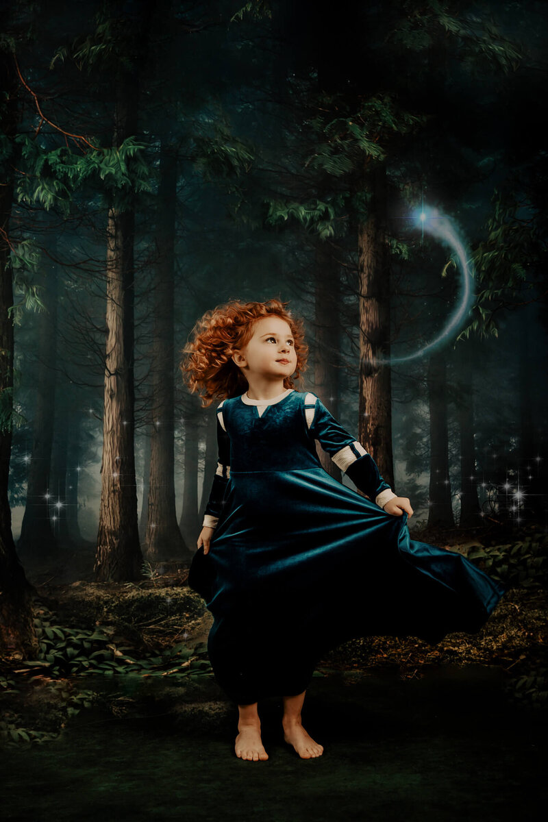 forest fantasy scene with a wisp and a red haired little girl wearing a Merida inspired dress by Only Little Once Designs