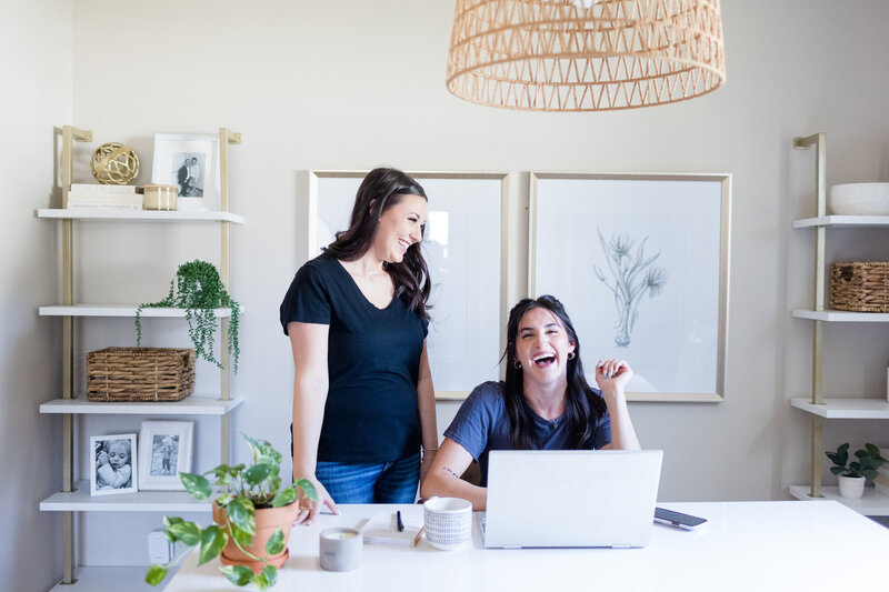 Two women laughing in office