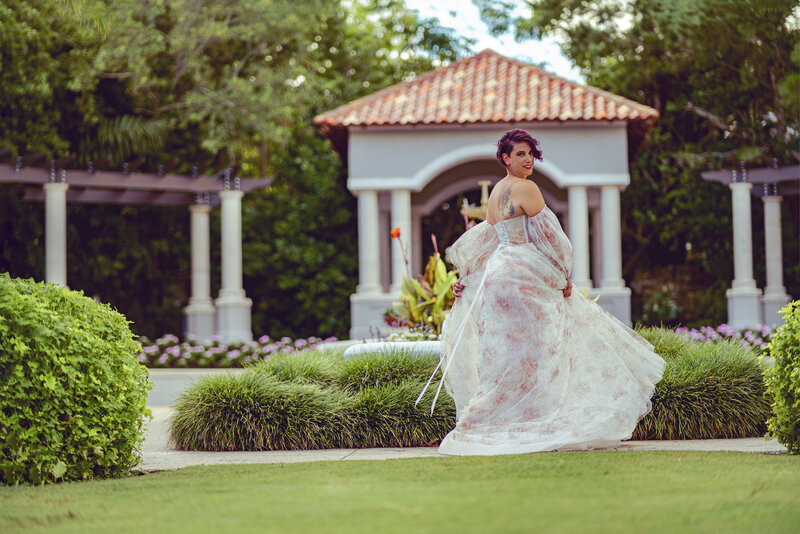 Stephanie Perry, photographer in Lakeland, Florida, dancing at Hollis Gardens wearing floral gown.