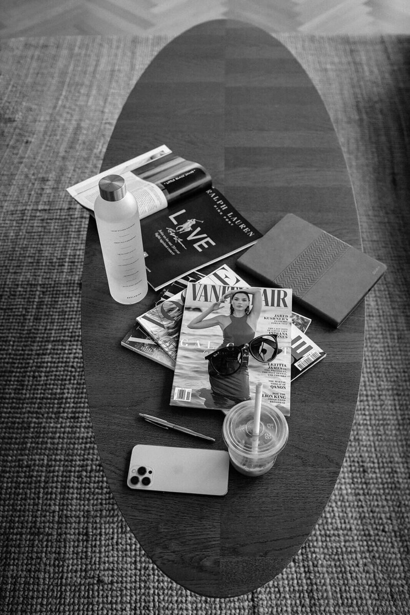 Black and white photo of magazines spread out on a table