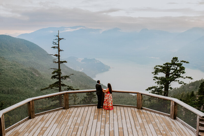 Bride and Groom married on the Sea to Sky gondola looking at the mountains