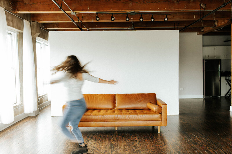 woman spinning in front of couch