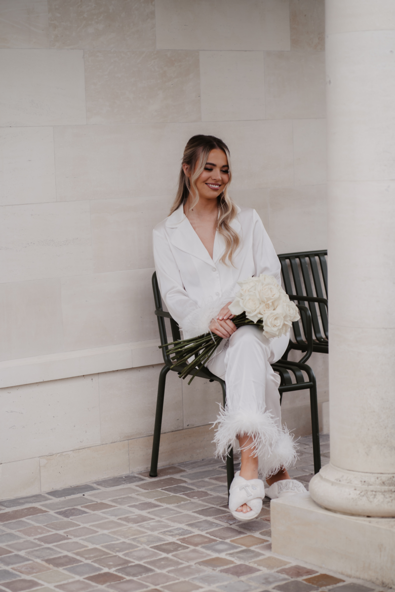 Bride in pyjamas pjs luxury silk satin with feathers single rose bouquet white roses sophisticated elegant Rudding Park Harrogate Mrs slippers luxe look