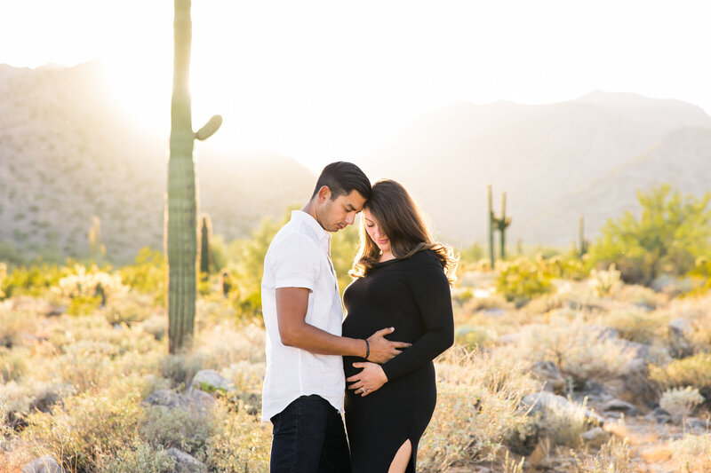 desert sunset maternity couple holding baby bump
