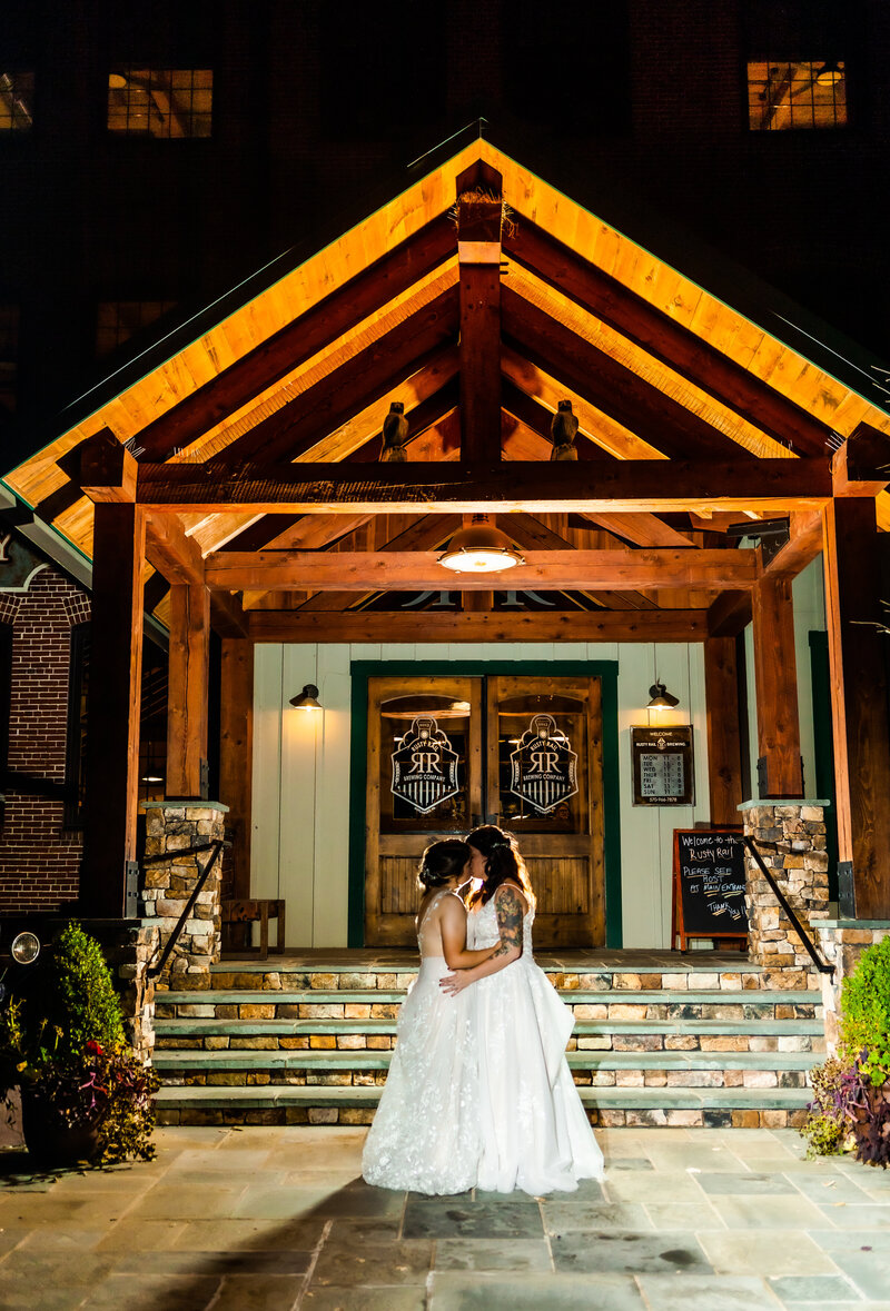 Brides kiss outside of Rusty Rail Brewery, PA Wedding Photographer
