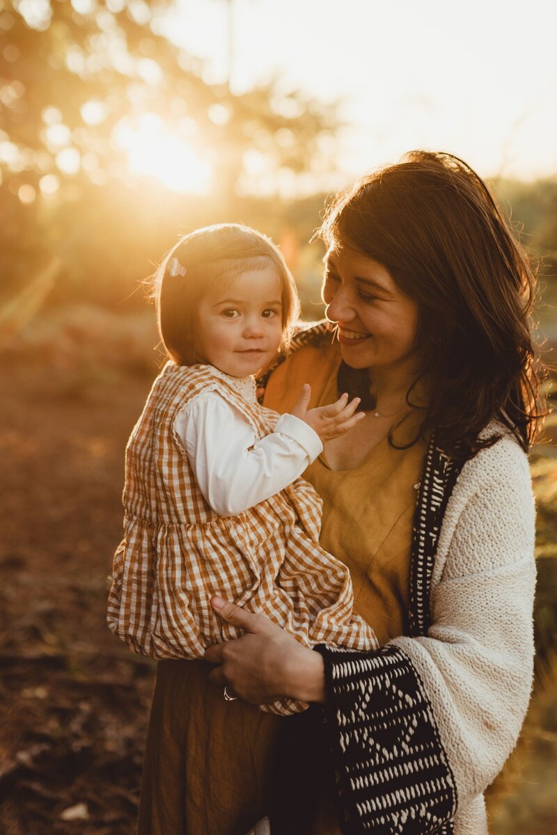 rustic natural autumn colours mother and daughter hugging natural sunset field outside