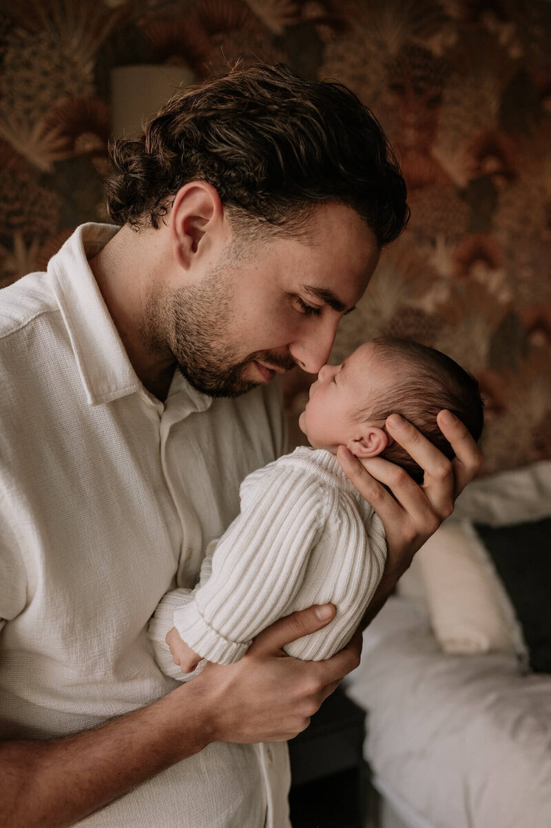 Papa geeft pasgeboren baby een zoentje