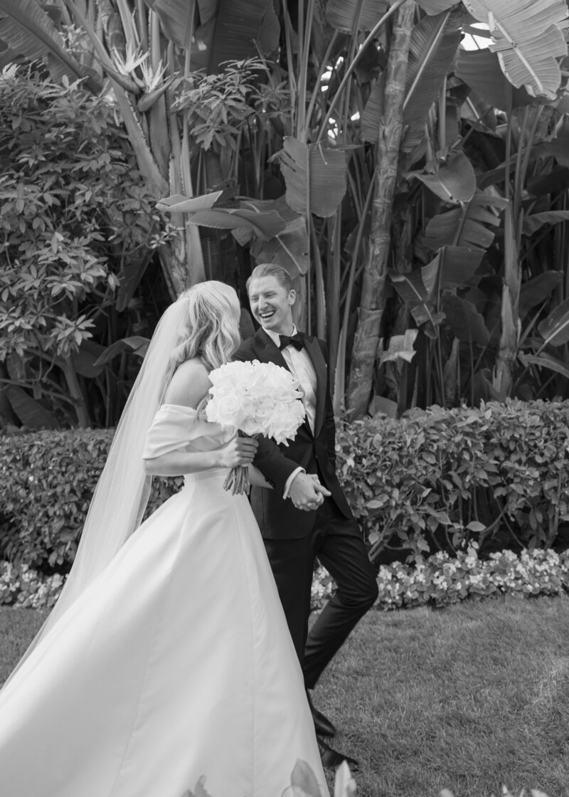 Bride and groom walking into cocktail hour at the Beverly Hills Hotel during their wedding