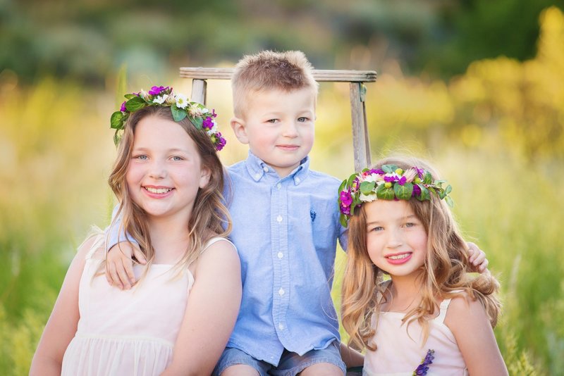 Spring photo session with a  boy and two girls wearing flower crowns
