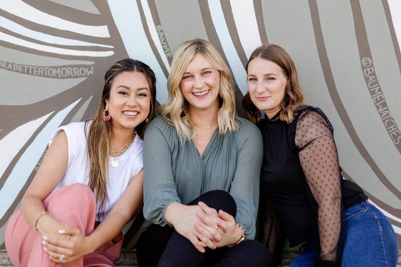 three female entrepreneurs pose for laid-back team photo in Venice, CA