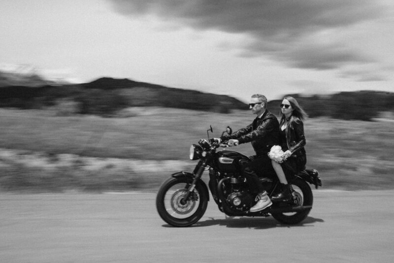 Couple riding off on a motorcycle during their Colorado elopement
