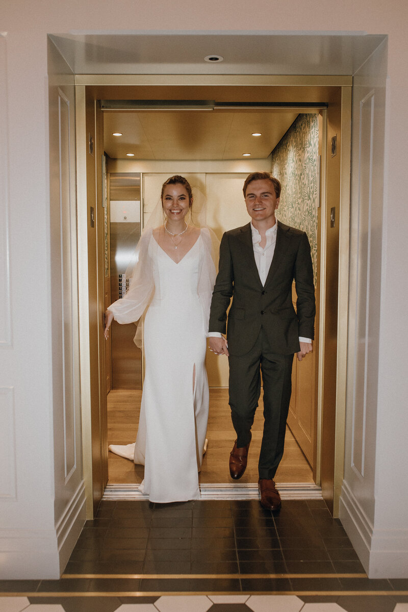 Bride and groom walking out of elevator