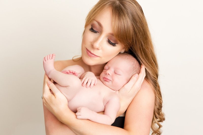 beautiful mom holding newborn boy