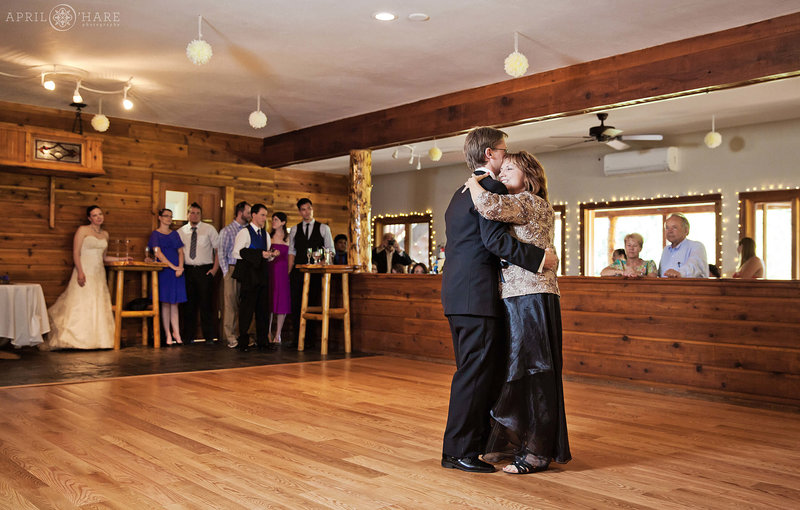 Groom Dances with his mom on the wood floor on the upper level of Wild Basin Lodge & Event Center in Allenspark Colorado