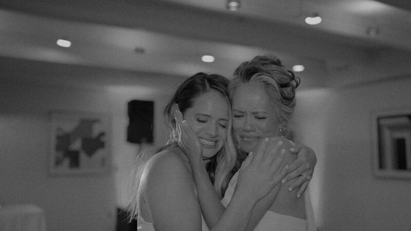 two women embracing and happy crying on wedding day
