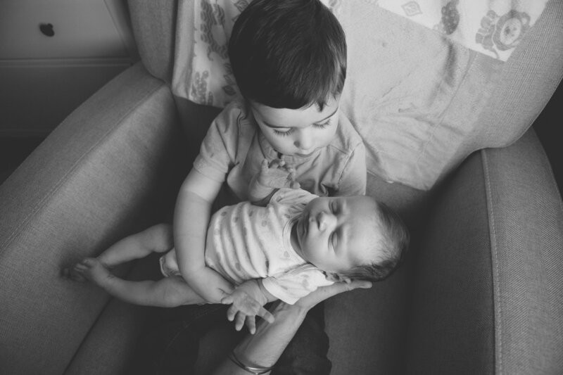 big brother holding baby
