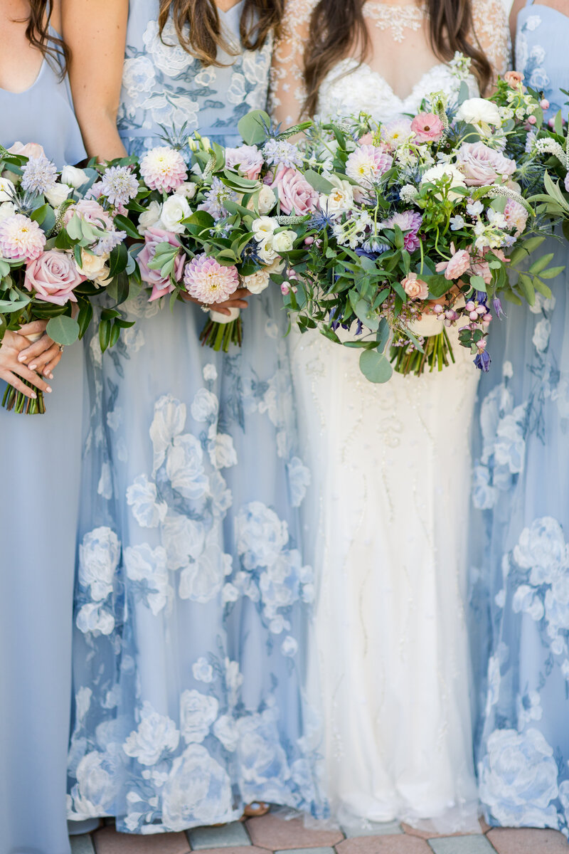 bridesmaids in floral pastel blue dresses