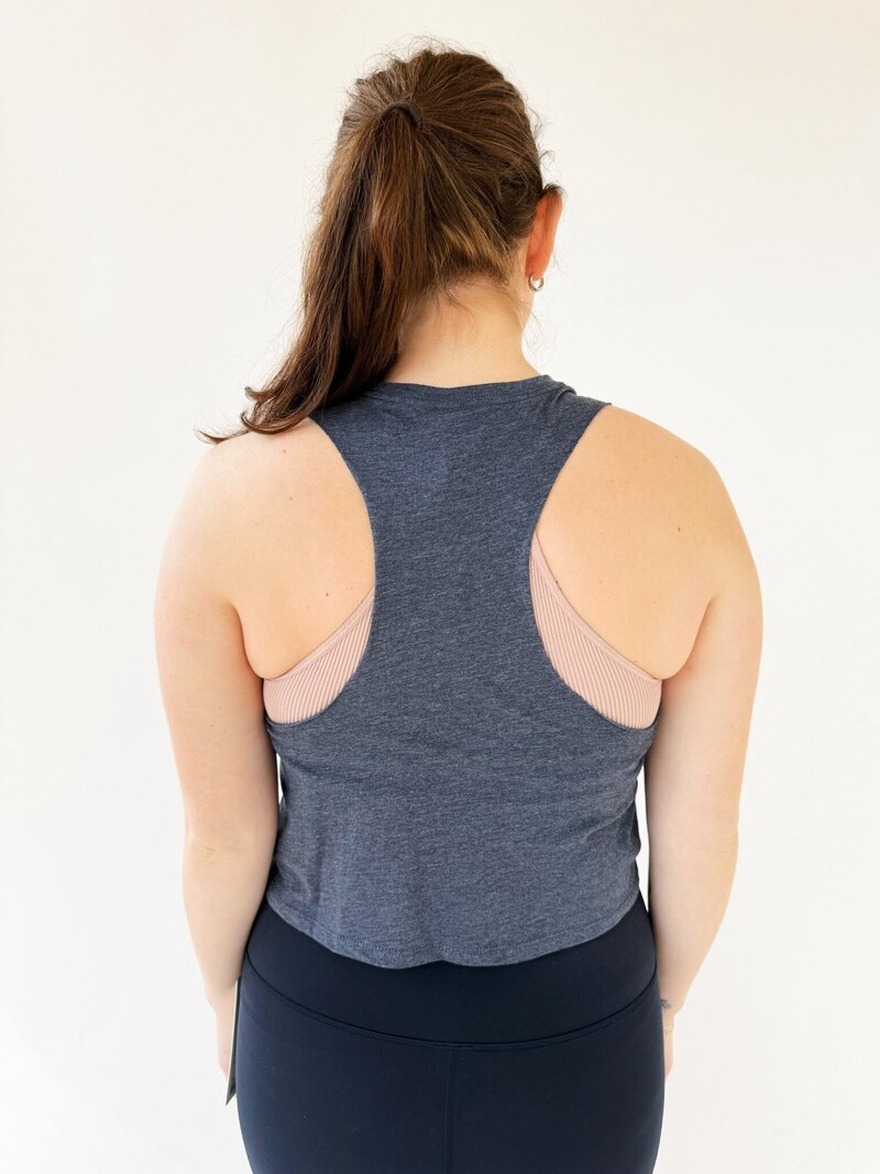 back of woman wearing navy high neck cropped tank