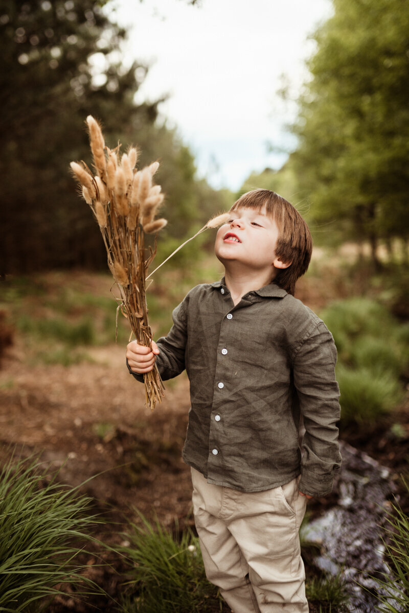 little boy outside nature field photoshoot