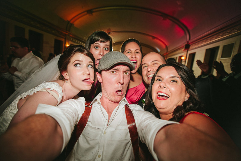 Funny selfie with bride, groom and photographer