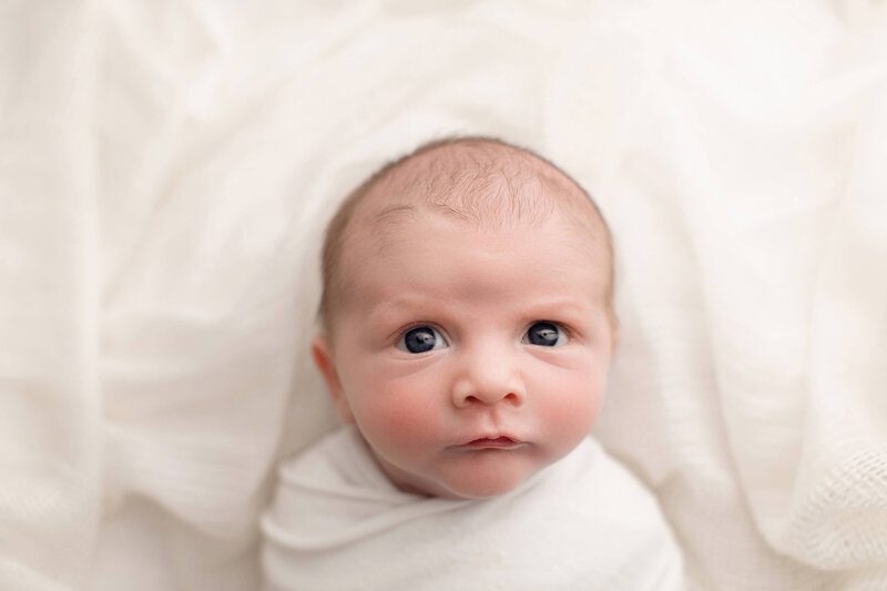 newborn boy in white wrap