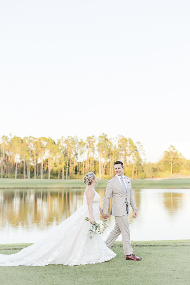 bride and groom walking on a golf course