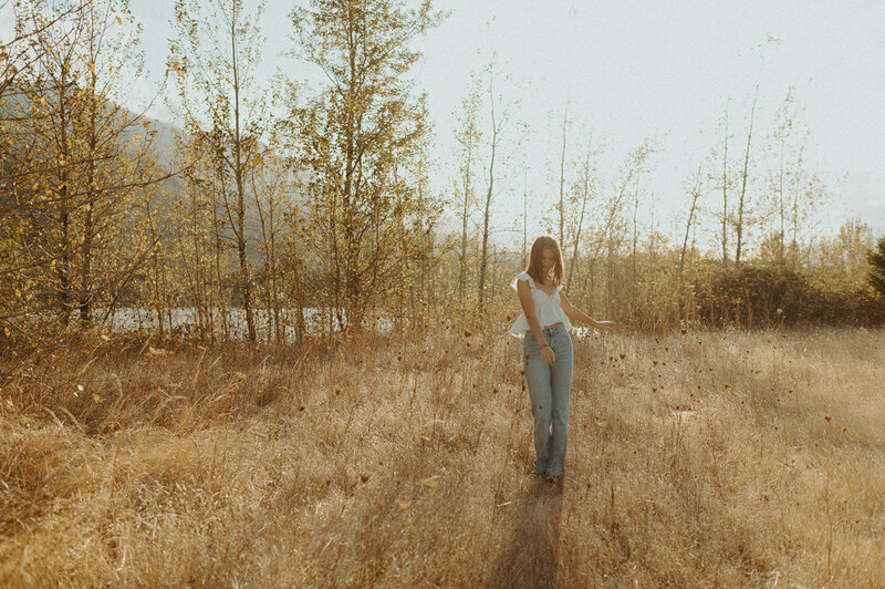 girl walking through field