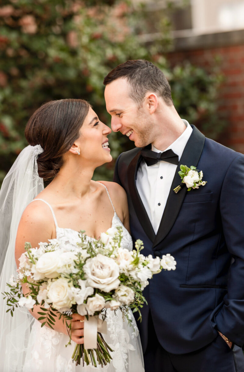 bride and groom, standing nose to nose inside the 18th century gardens of Philadelphia