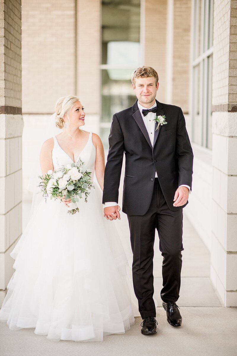 holding hands and walking by Knoxville Wedding Photographer, Amanda May Photos