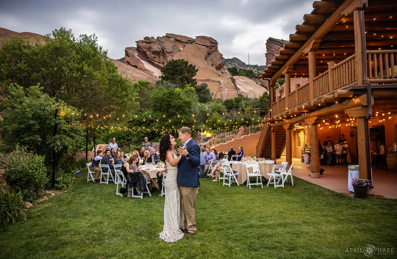 Red Rocks Trading Post Backyard First Dance at Dusk with String Lights in the Backdrop