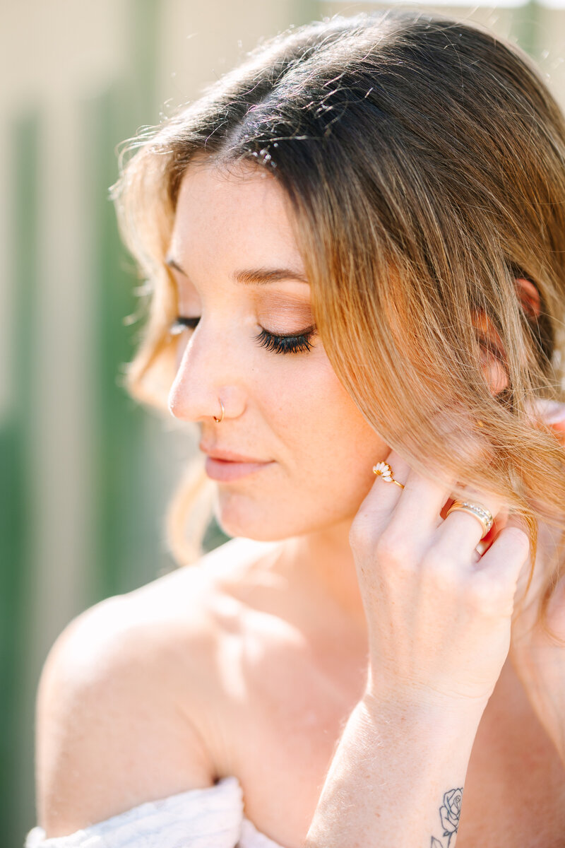 close-up shot of a bride putting on her earrings.