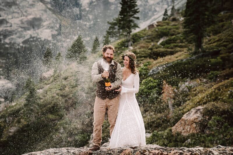 California elopement couple popping champagne