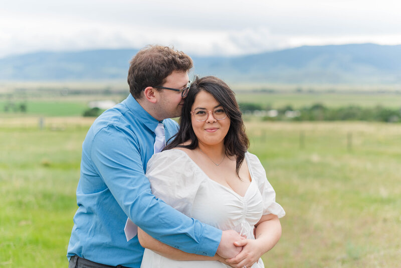 A man hugs his bride at his family's history ranch outside Bozeman, Montana by Laramee Love Photography