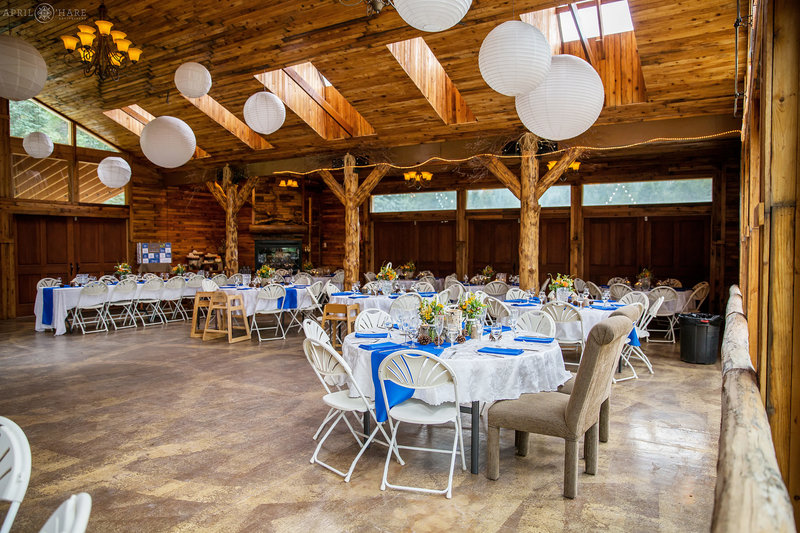 Blue and white wedding reception decor inside barn at Mountain Virew Ranch Wedgewood Weddings
